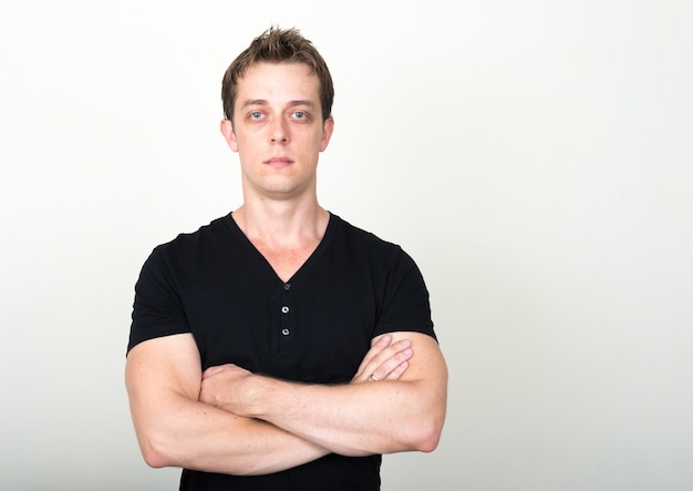  handsome man with brown hair against white wall