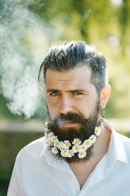 Handsome man with flowers in beard