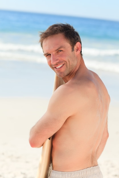 Handsome man with his surfboard