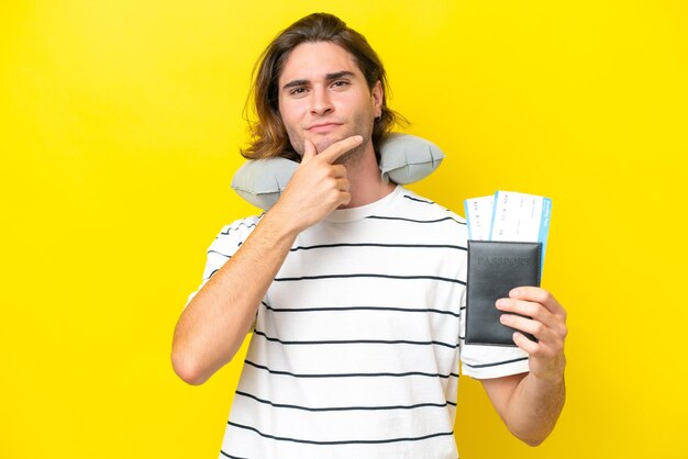 Handsome man with inflatable travel pillow thinking