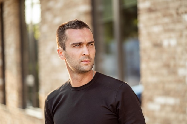 Handsome man with short bristles in a black tshirt Portrait