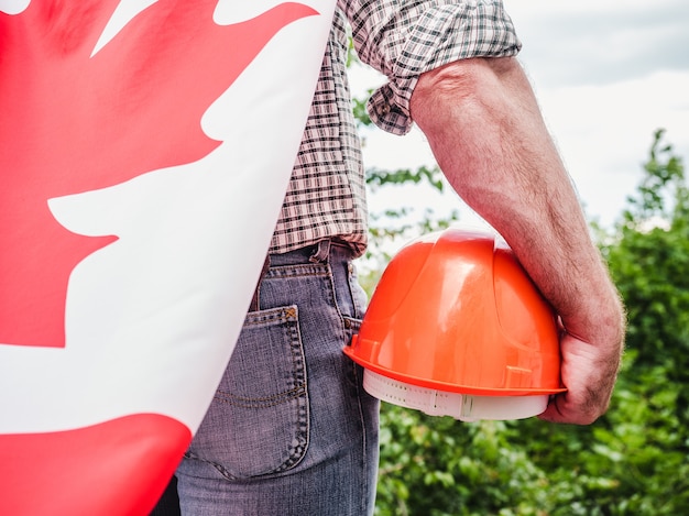 Handsome man with tools, holding an American Flag