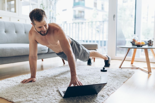 Premium Photo | Handsome man working out at home