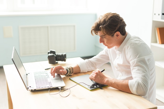 Handsome man working with graphic tablet