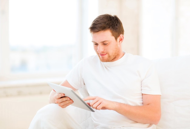 handsome man working with tablet pc at home