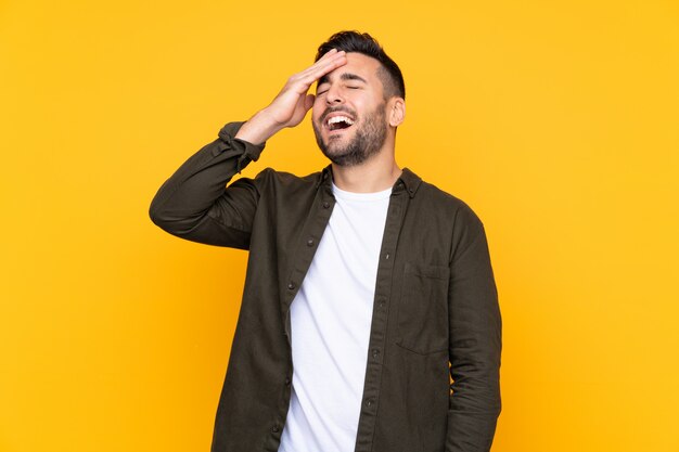 Handsome man over yellow wall