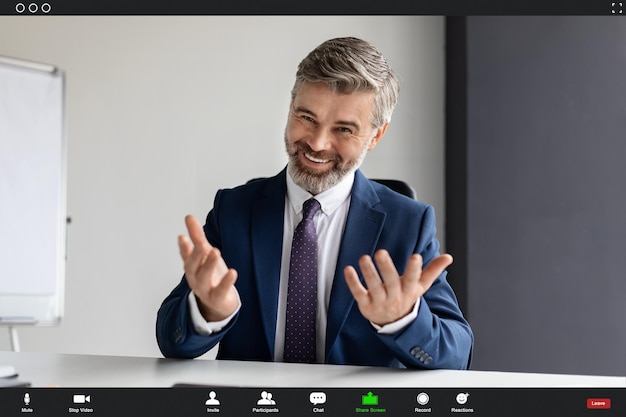 Photo handsome mature businessman making video call from office pov screenshot