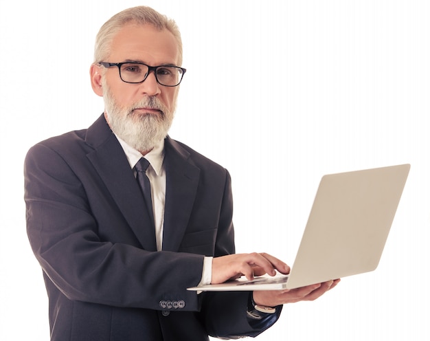 Handsome mature businessman with gadget.