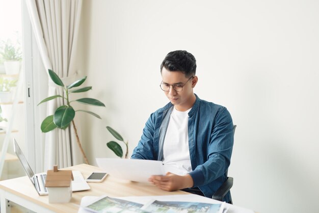 Handsome mature male architect working at office desk