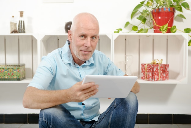 Handsome mature man using tablet