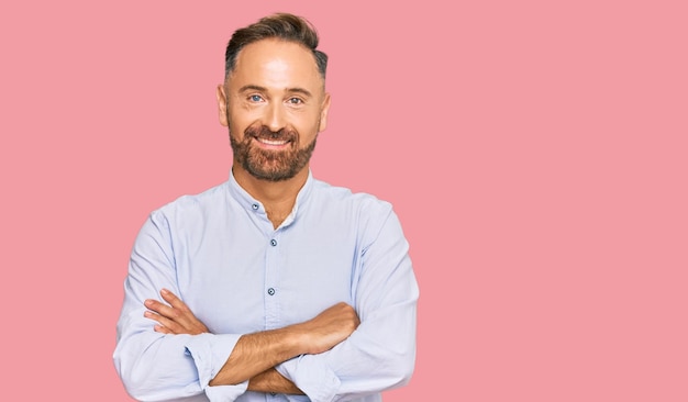 Handsome middle age man wearing business shirt happy face smiling with crossed arms looking at the camera positive person