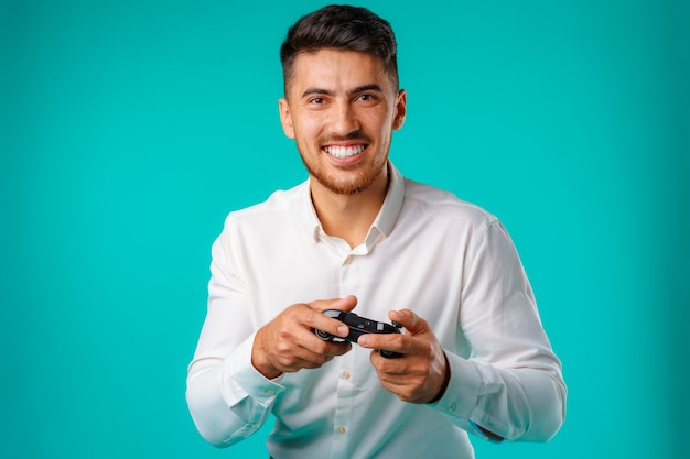 Handsome mixed race man holding video games joystick