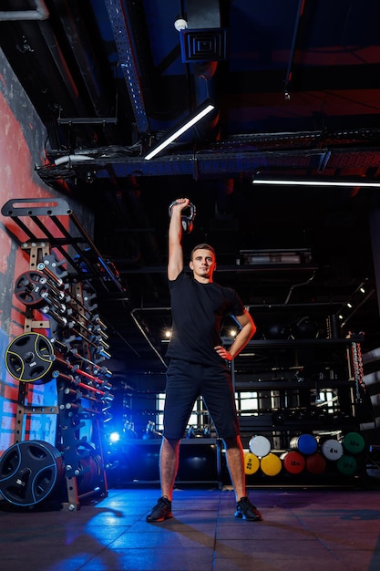 Handsome muscular man performing heavy exercises in the gym. Healthy lifestyle