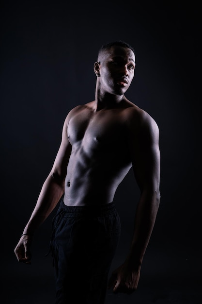 A handsome and muscular young man posing in the studio