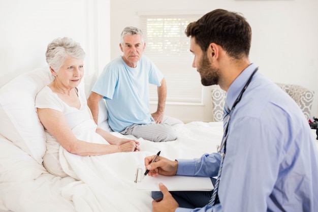 Handsome nurse visiting a mature woman at home