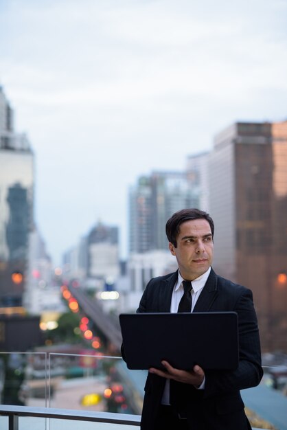 Handsome Persian businessman against view of the city