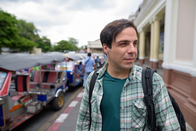 Handsome Persian tourist man exploring the city of Bangkok, Thai