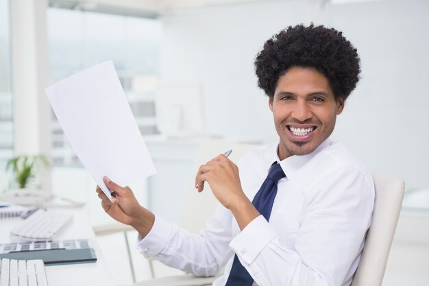 Handsome photo editor working at desk