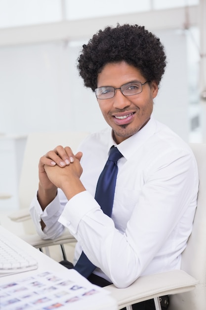 Handsome photo editor working at desk