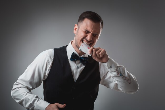 Handsome poker player with two aces in his hands