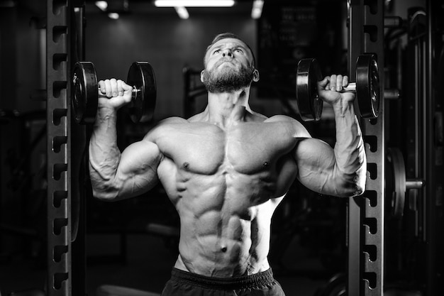 Handsome powerful bodybuilder at the gym