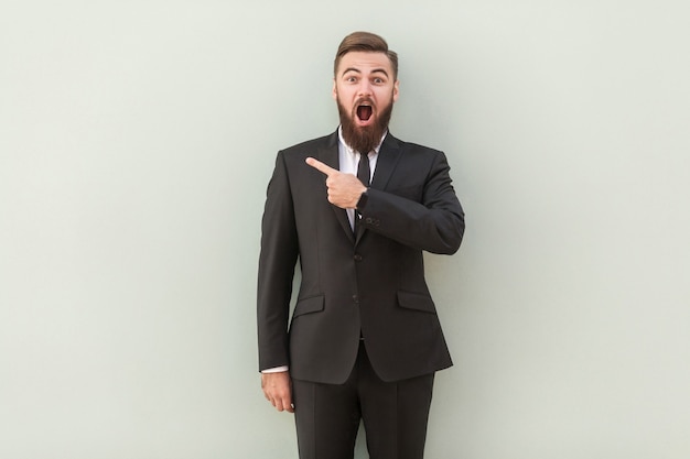 Handsome presenter of your advertisement happy young man in formalwear