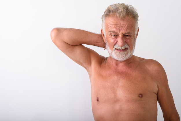 handsome senior bearded man having neck pain shirtless on white