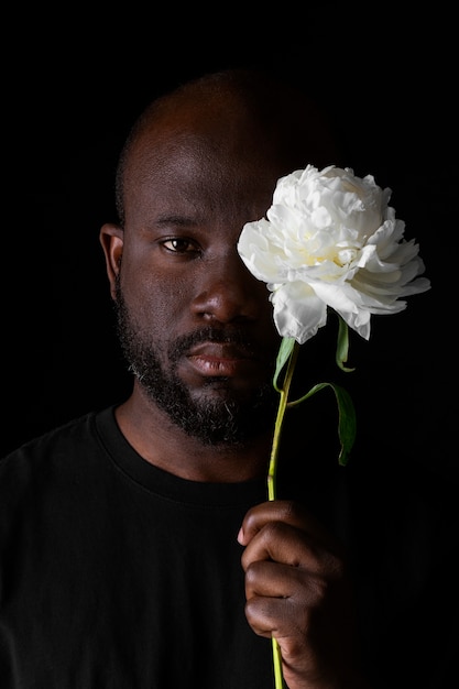 Handsome and sensitive man with flower