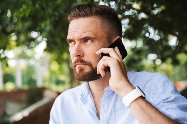 Handsome serious young bearded man