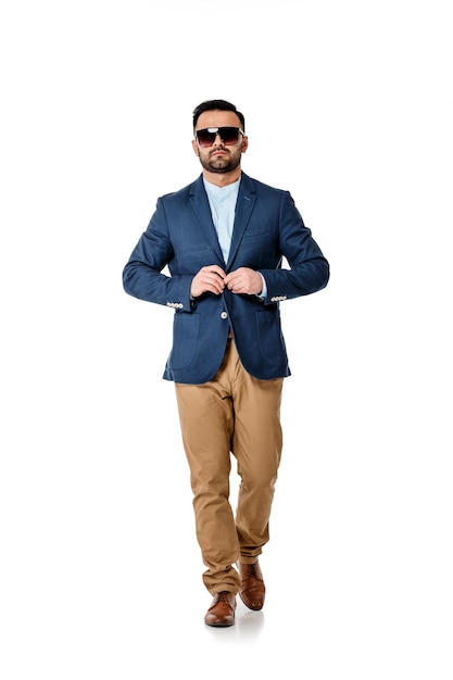 Handsome sexy man in sunglasses and suit on white background