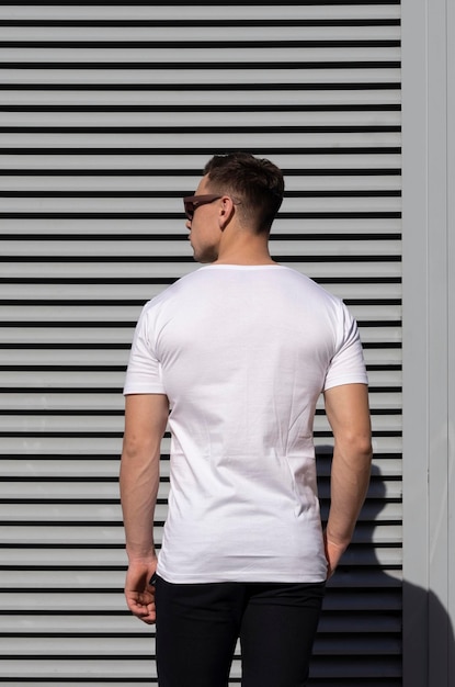 Handsome sexy man in white tshirt and sunglasses white tshirt mockup back view