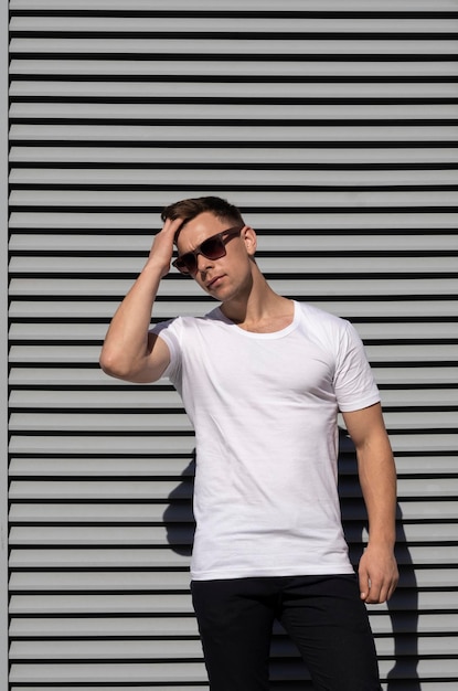 Handsome sexy man in white tshirt and sunglasses white tshirt mockup front view