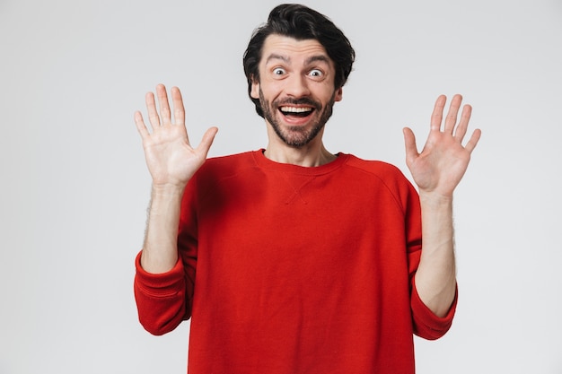 Photo handsome shocked young man isolated over white wall.