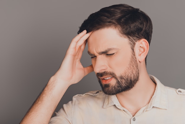 Handsome sick man touching head and feeling pain