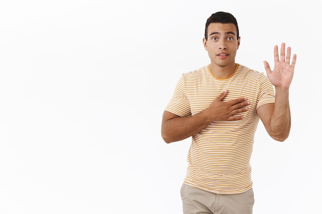 Handsome, sincere caucasian, masculine man giving his word telling truth