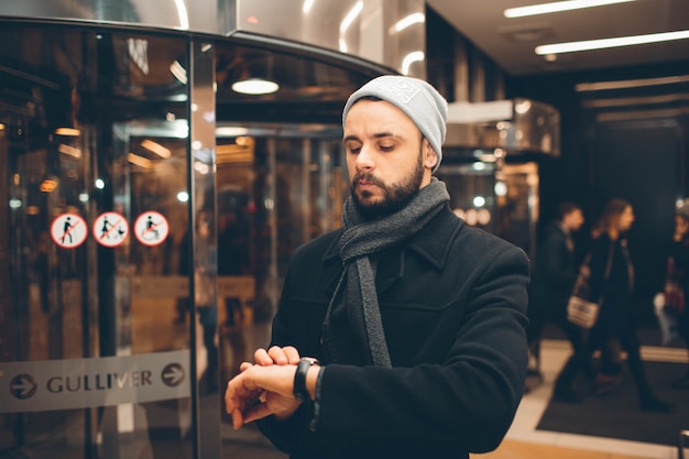 Handsome sman looking at his watch