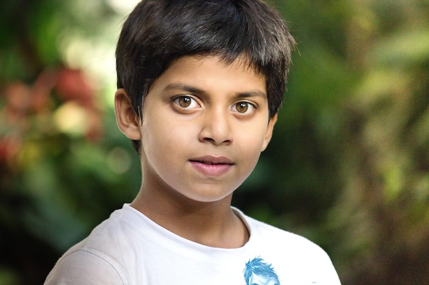 A Handsome smart Happy Indian kid looking  at a distance Close up emotions of little male child