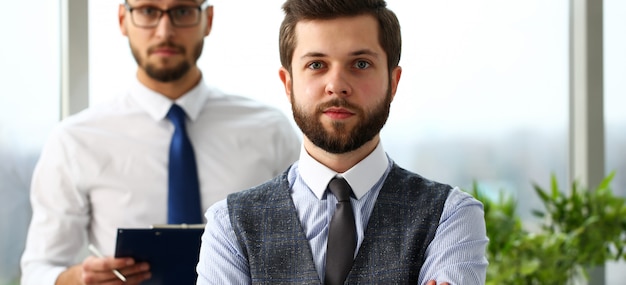 Handsome smiling bearded clerk man at workplace