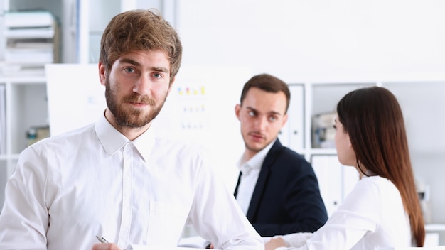 Handsome smiling bearded man in office