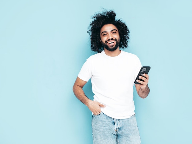 Handsome smiling hipster man posing in studio