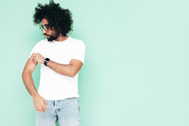 Handsome smiling hipster man posing in studio