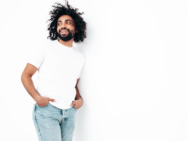 Handsome smiling hipster man posing in studio