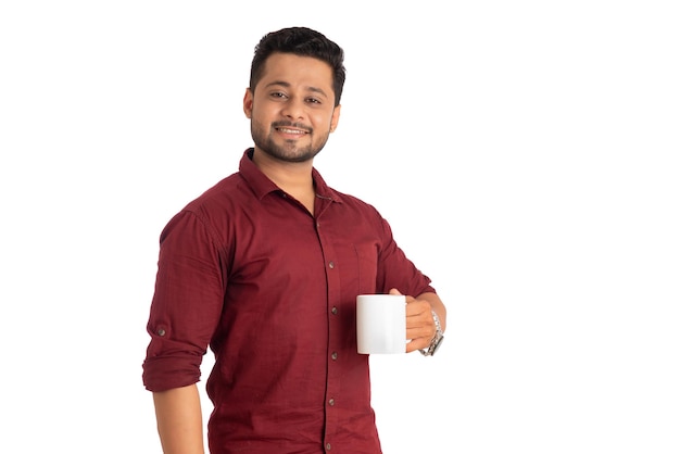Handsome smiling man with cup of coffee or tea isolated on white background