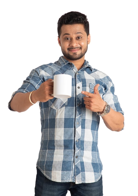 Handsome smiling man with cup of coffee or tea isolated on white background