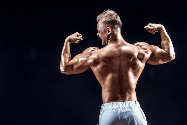 Handsome strong bodybuilder posing in