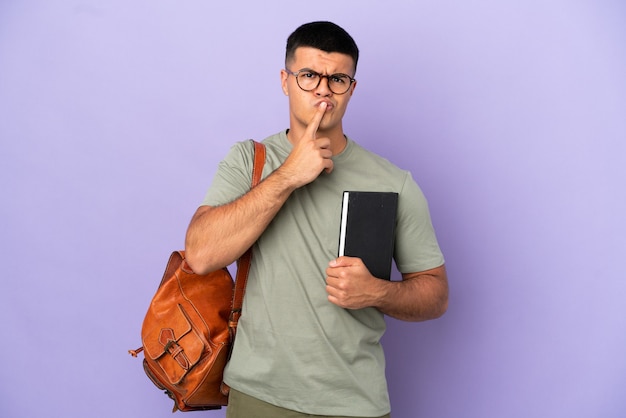 Handsome student man over isolated background having doubts while looking up