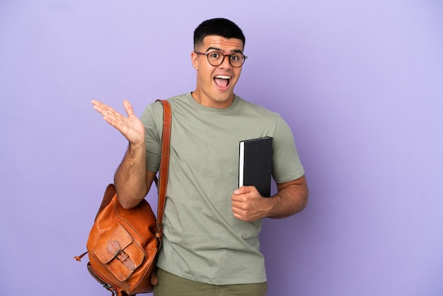 Handsome student man over isolated background with shocked facial expression