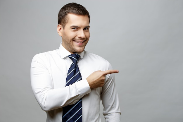 Handsome stylish businessman on grey background