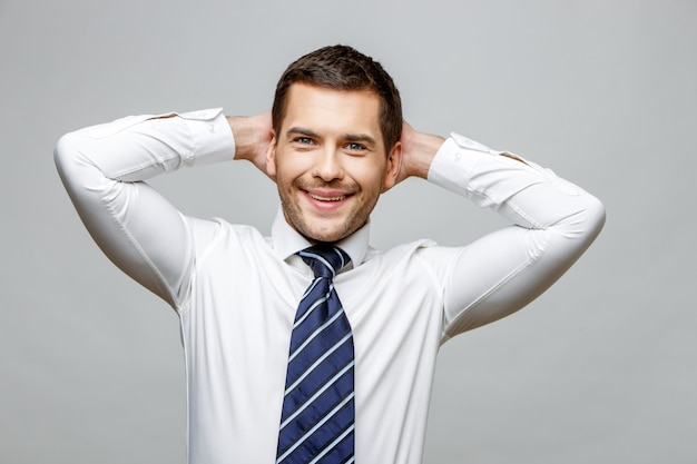 Handsome stylish businessman on grey background