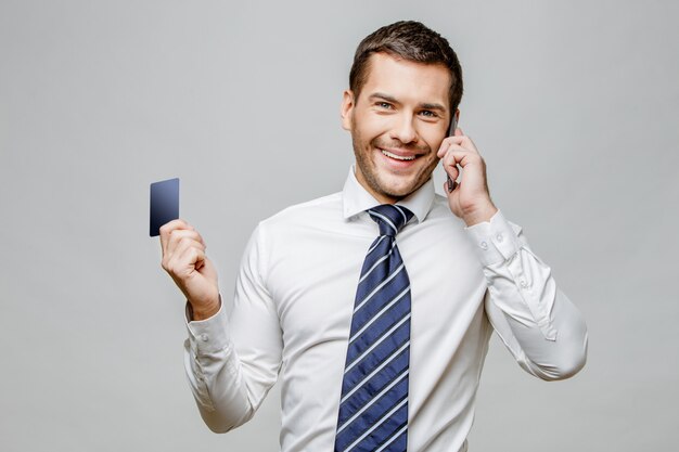 Handsome stylish businessman on grey background